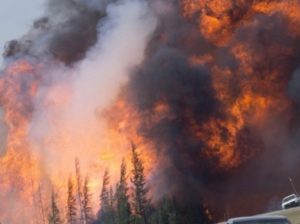 A giant fireball is seen as a wild fire rips through the forest 16 km south of Fort McMurray, Alberta on highway 63 Saturday, May 7, 2016. THE CANADIAN PRESS/Jonathan Hayward